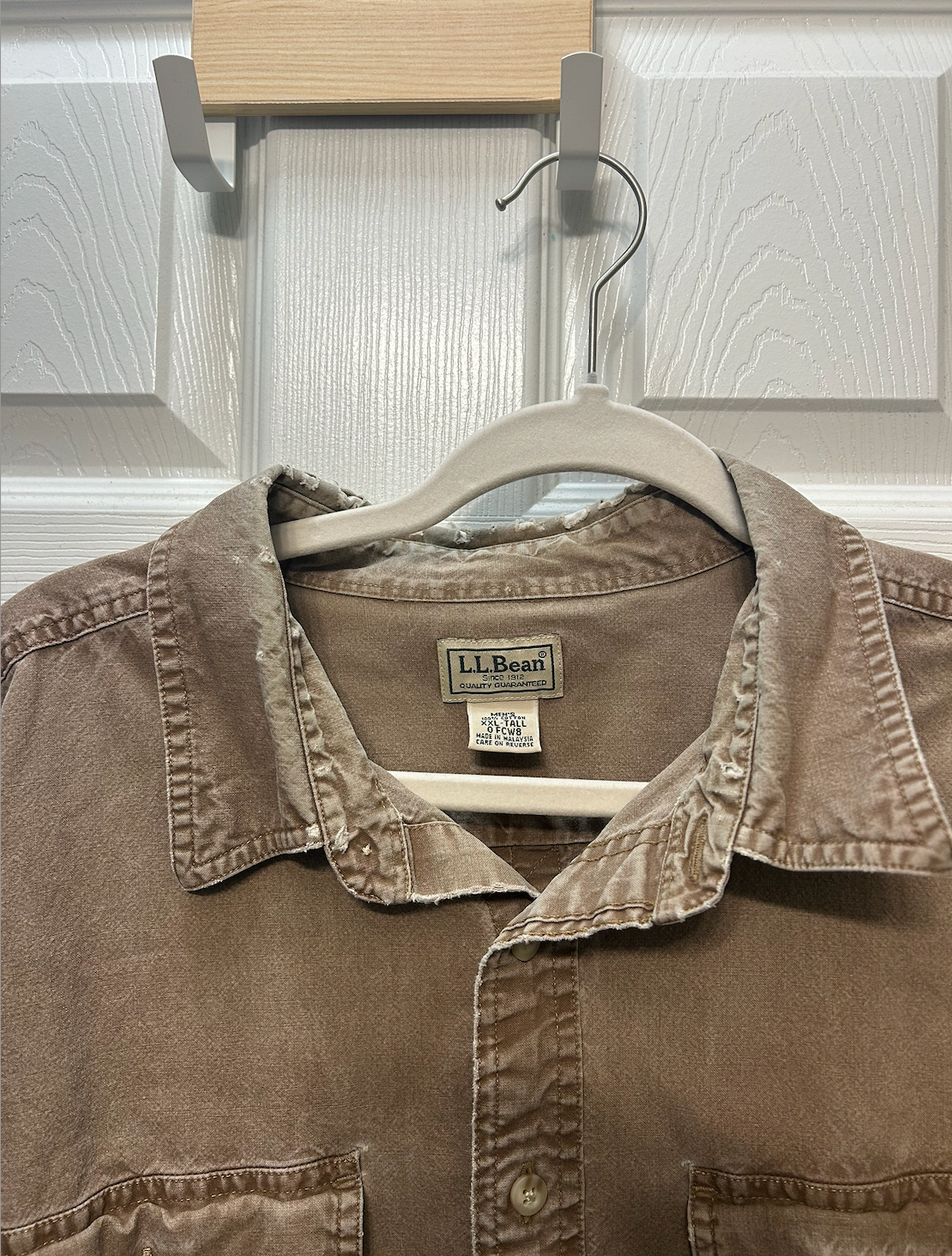 L.L.Bean long-sleeve button-down work shirt in a tan/khaki color with dual chest pockets.