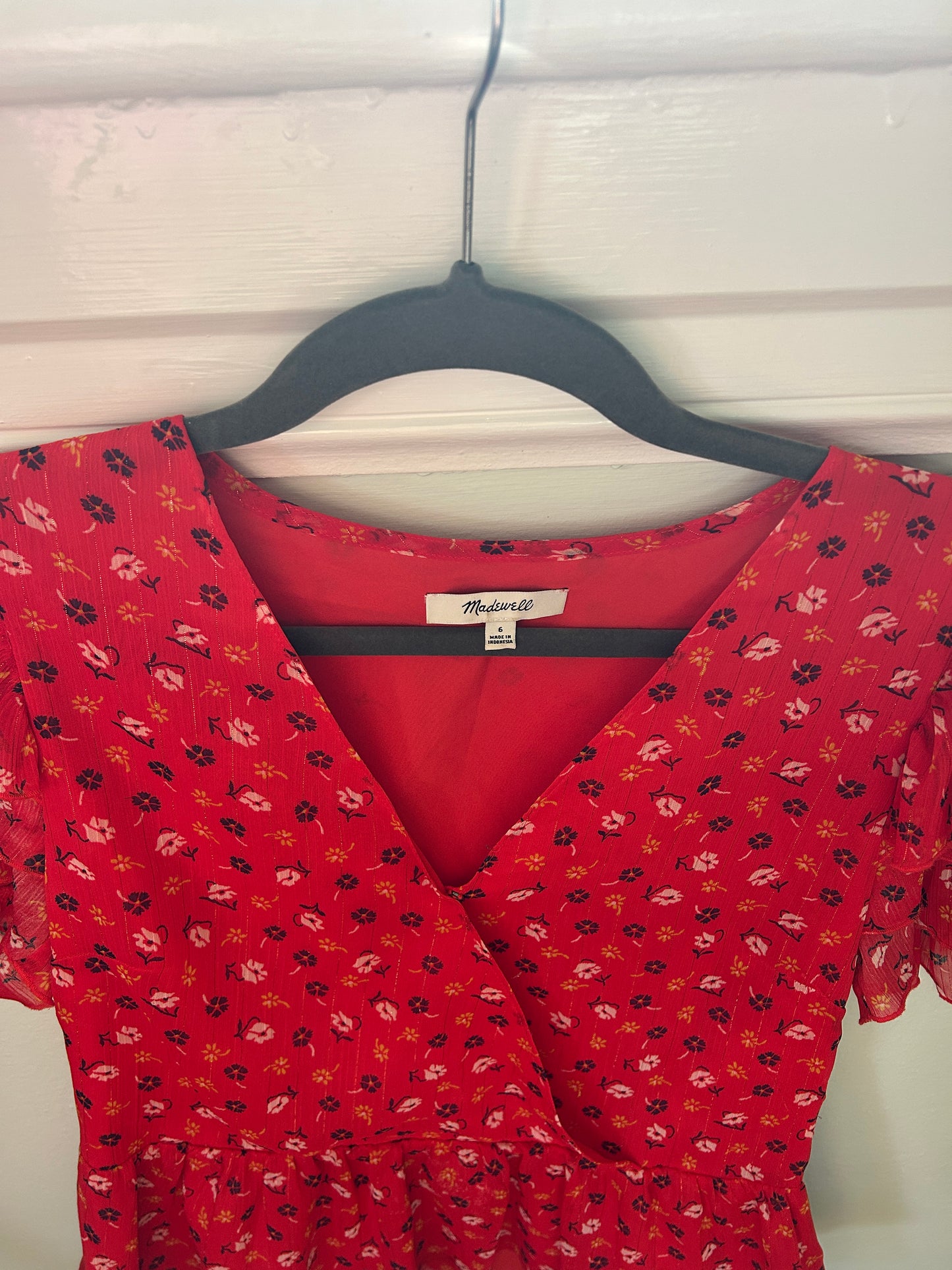 Madewell red floral wrap-style blouse with ruffled flutter sleeves and peplum hem.
