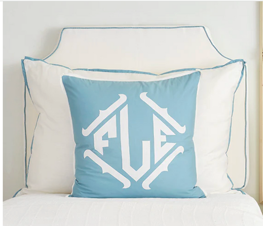 Room 422 white rectangular bed pillow with light blue piping trim along the edges.