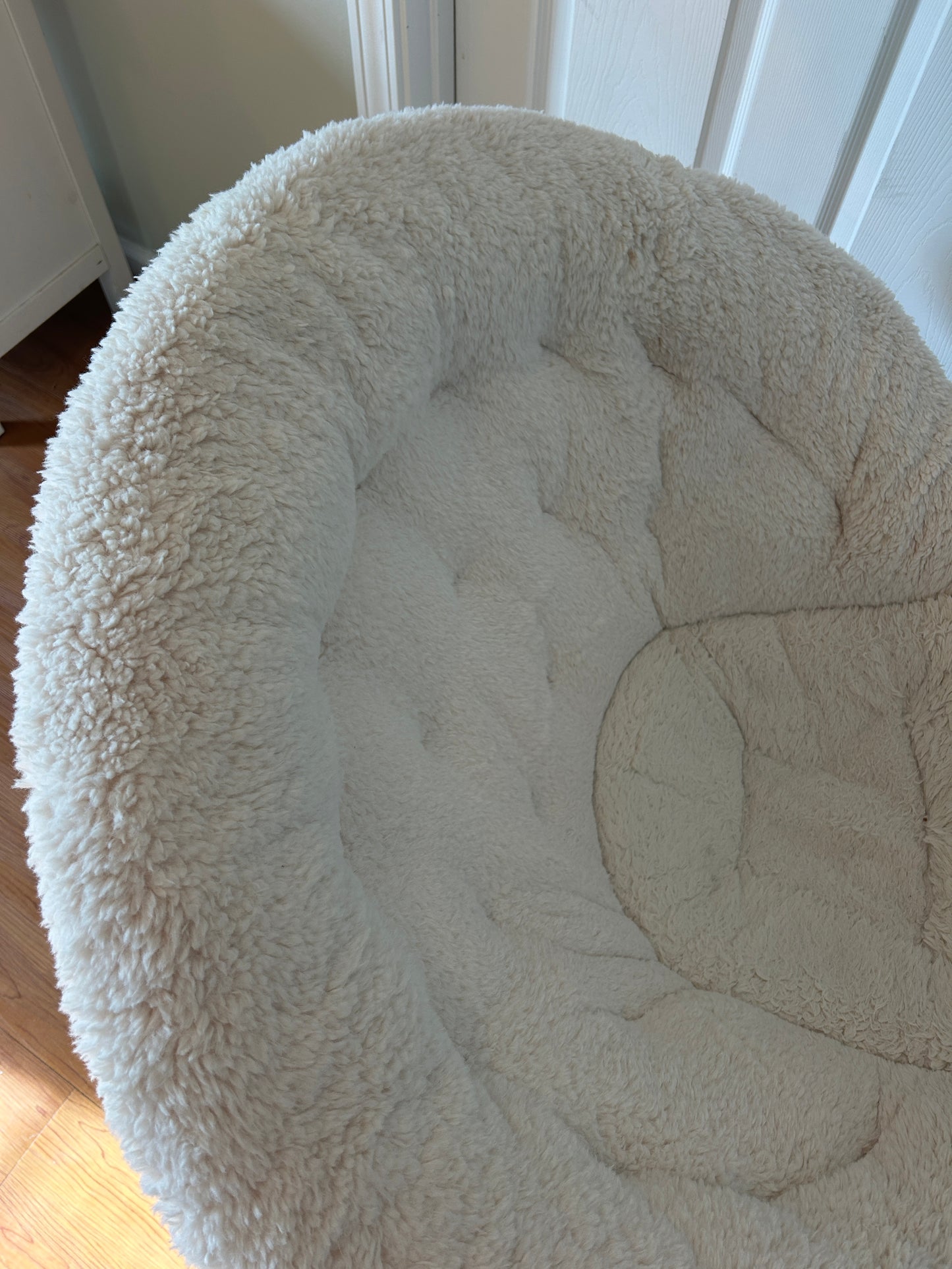 White faux fur saucer chair with metal frame, popular for dorm rooms and lounging.