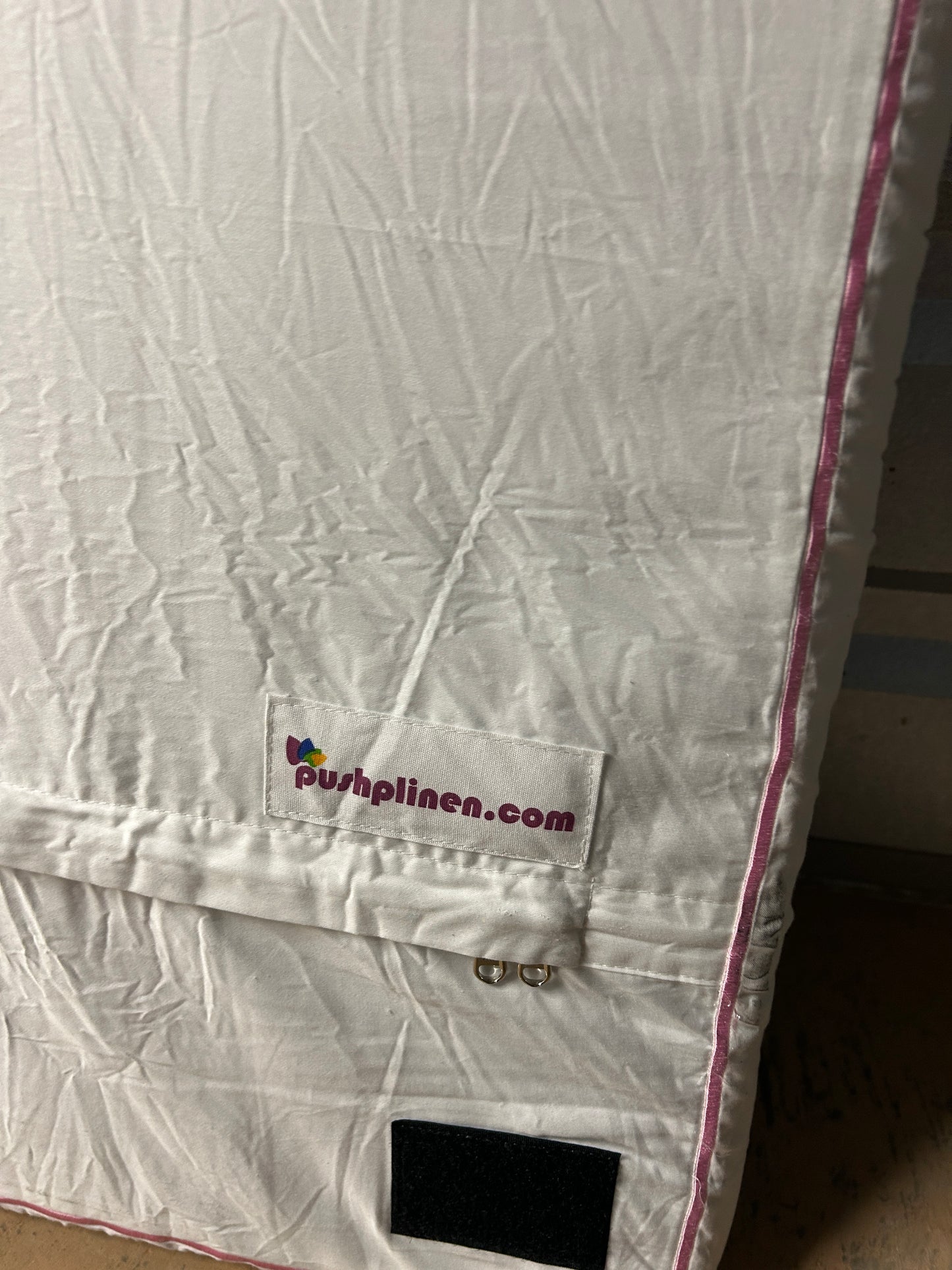 PushpLinen twin headboard with light pink piping trim along edges.