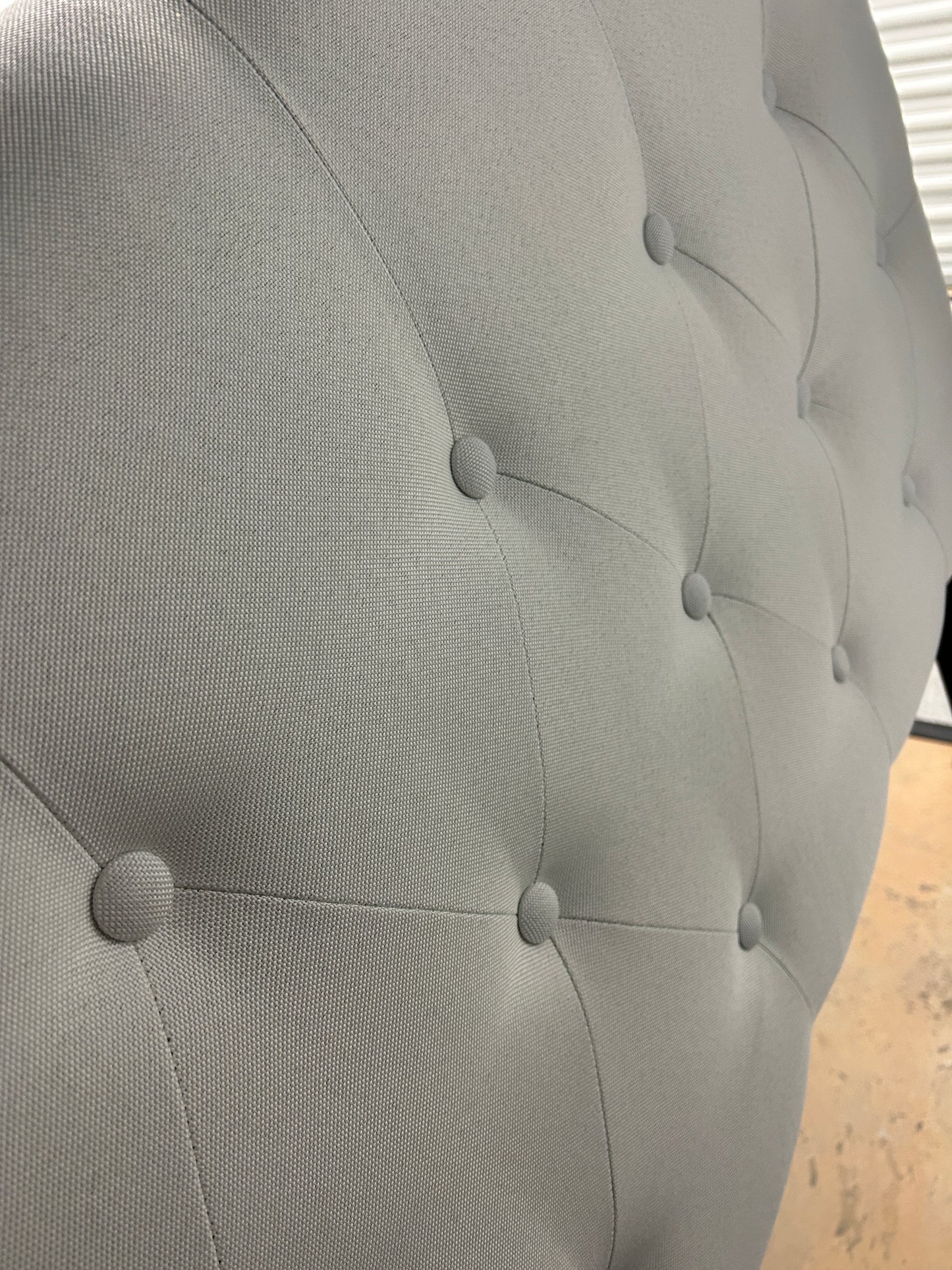 Gray twin headboard with black metal legs.