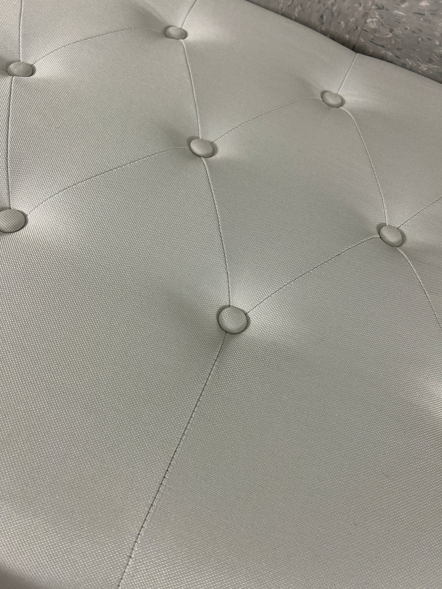 White queen upholstered tufted headboard with diamond button detailing.