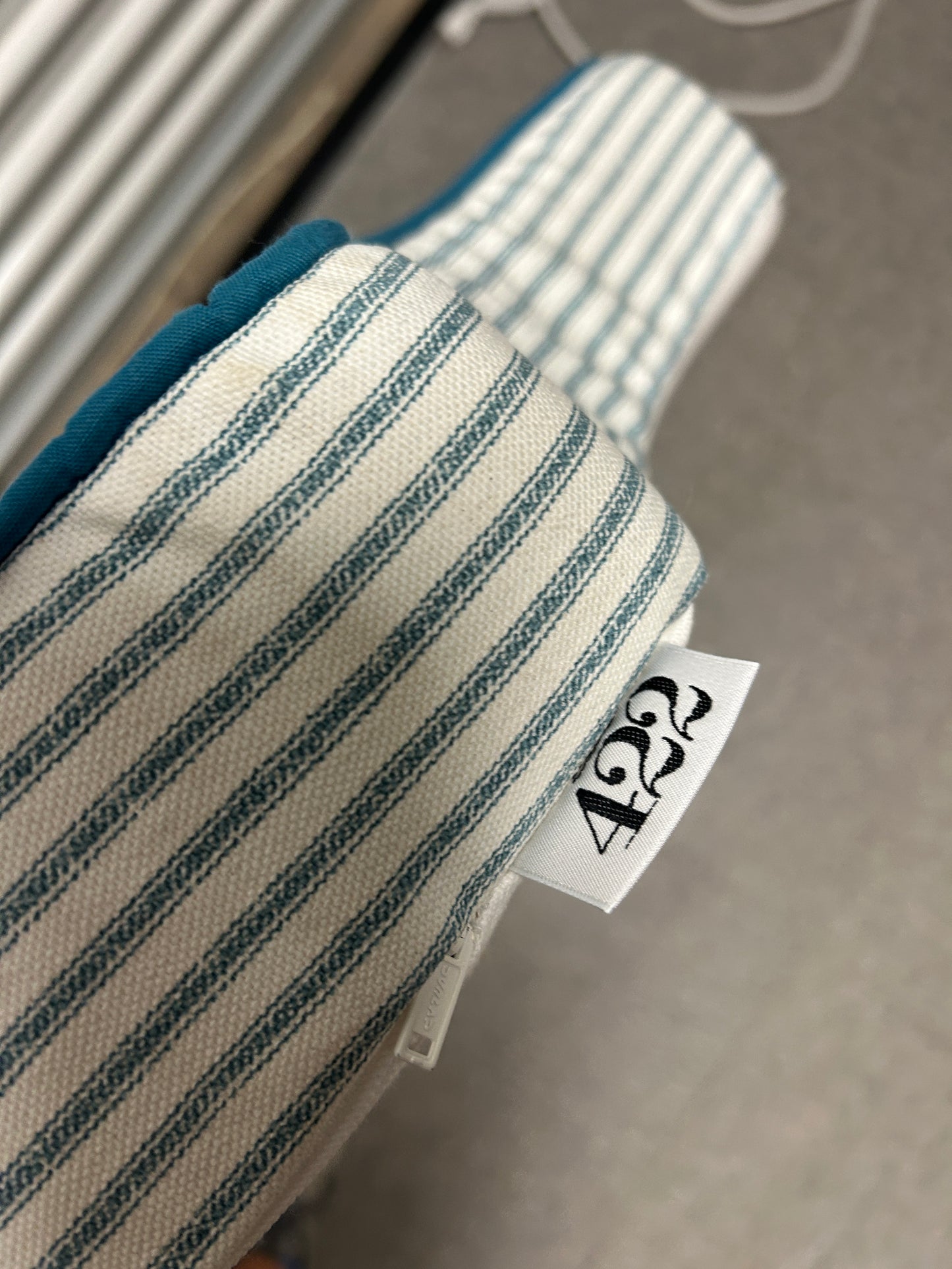Room 422 twin blue and white striped headboard with blue piping trim along the edges.
