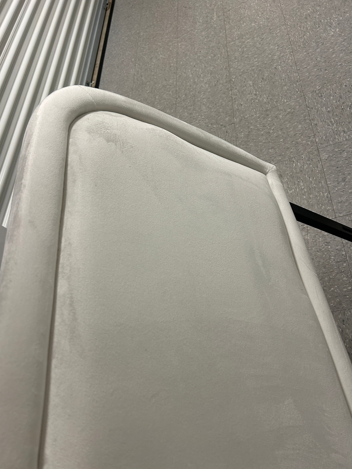 White queen velvet headboard with black metal legs.