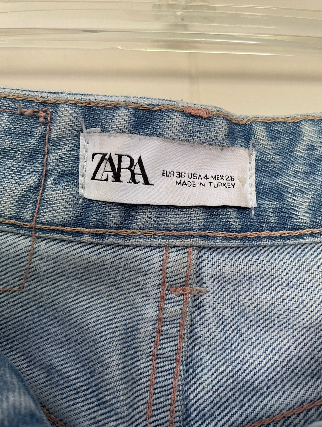 Zara light wash high-waisted jeans with a raw hem.