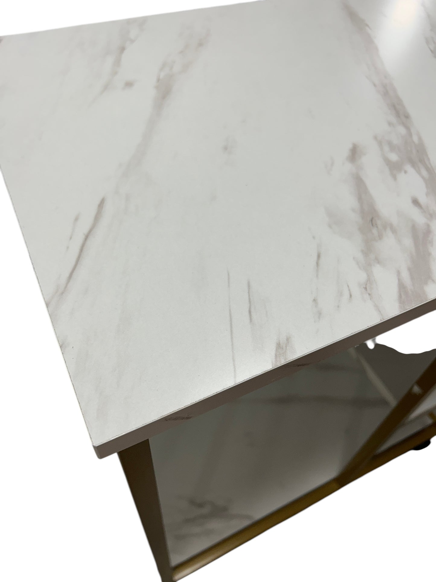 Gold bar cart with marble-like shelves.