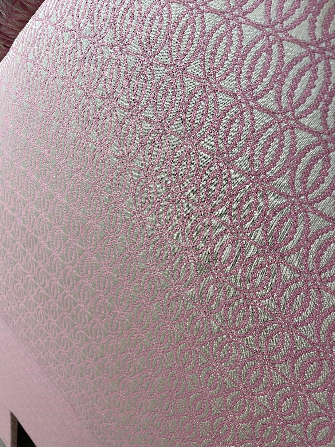 Custom-built pink and white patterned twin headboard.