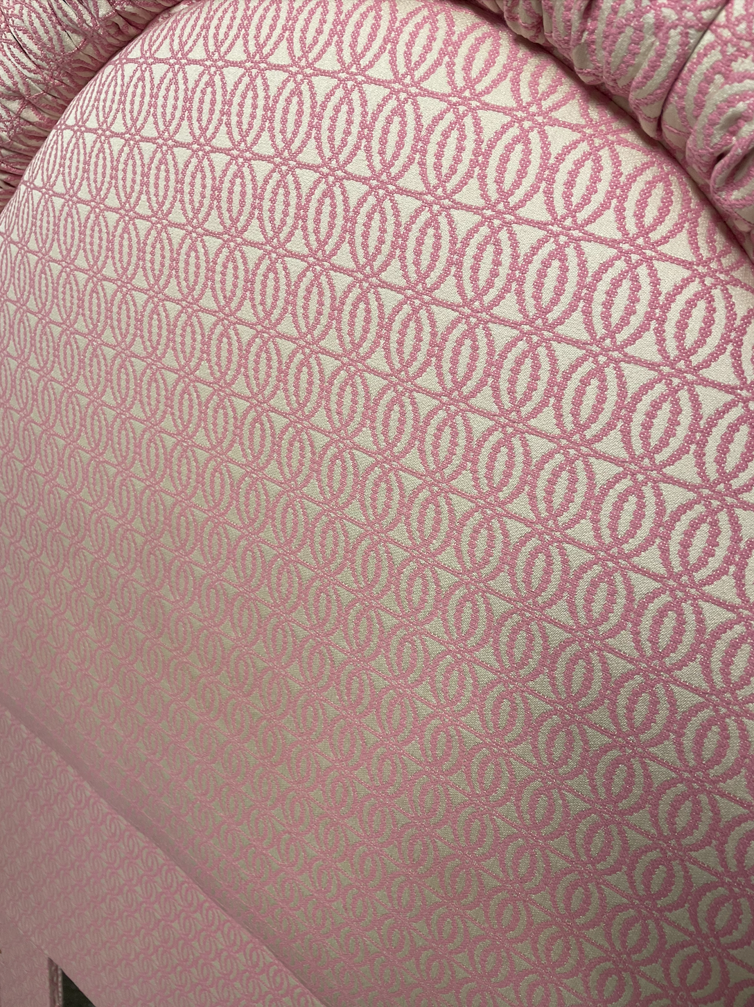 Custom-built pink and white patterned twin headboard.