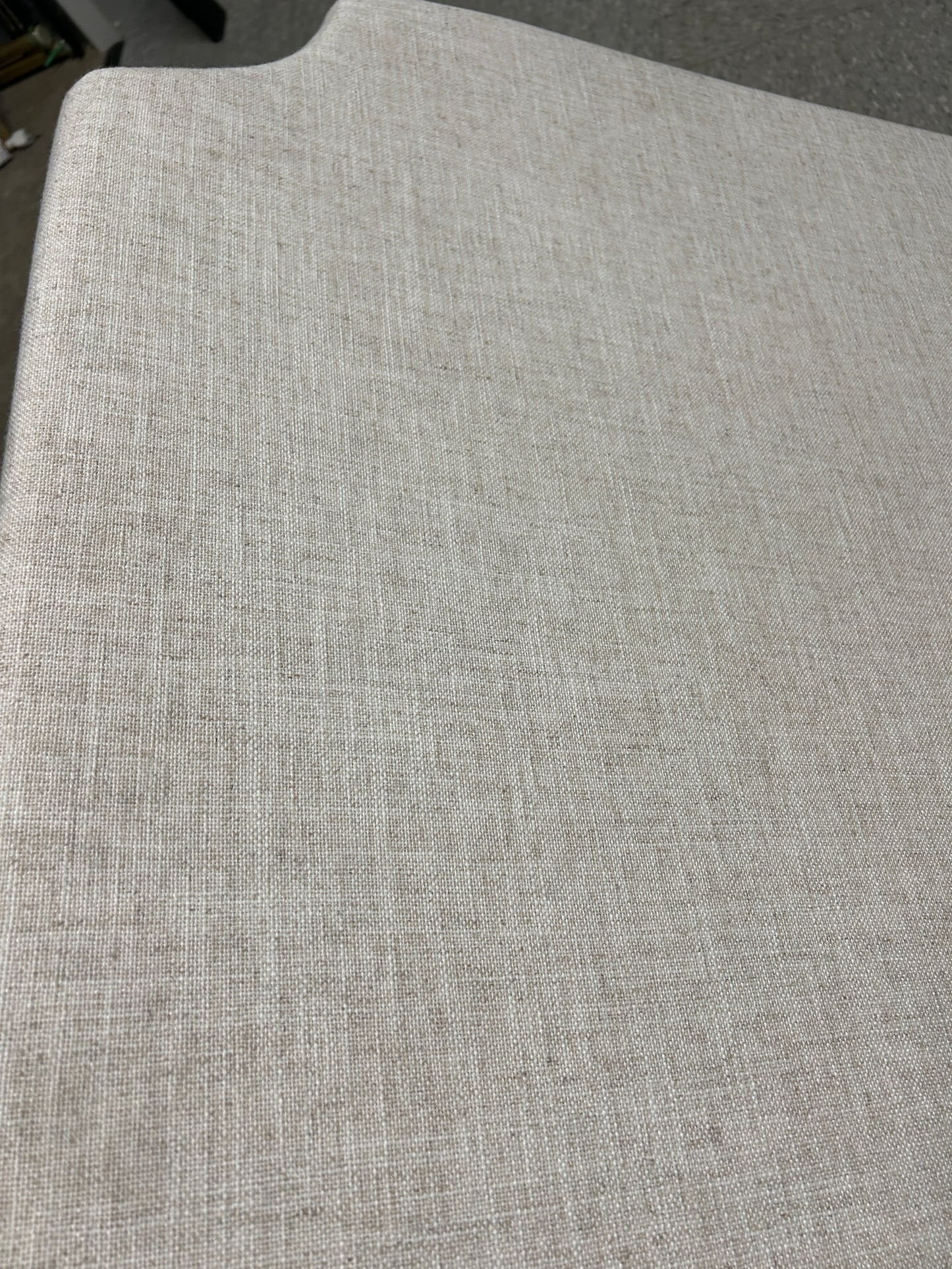 Beige twin headboard with curved notched corners.