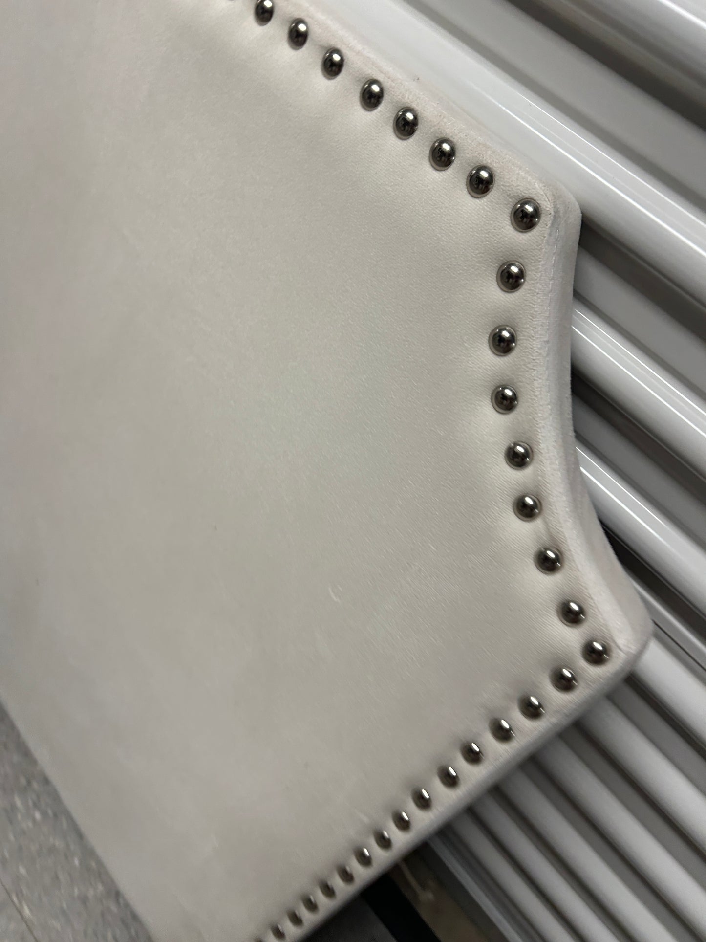 Cream velvet twin headboard with silver buttons.