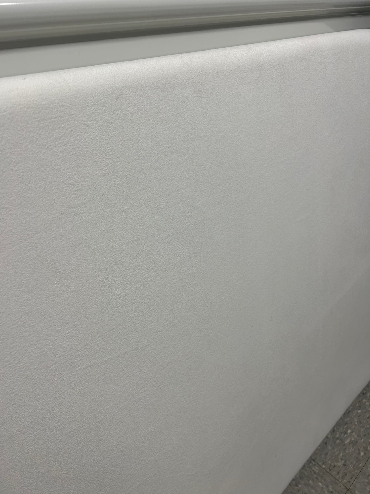 Cream velvet twin headboard with a notched corner.