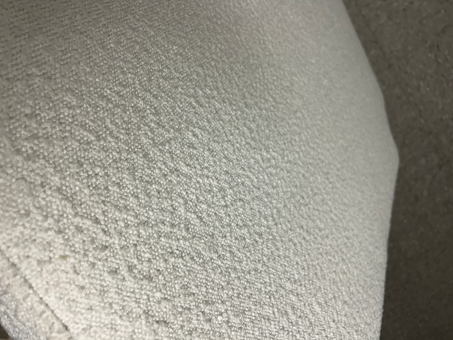 White twin headboard with bouclé fabric and a charging outlet.