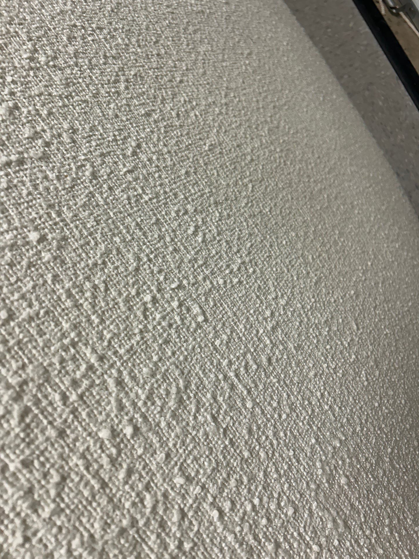 White twin headboard with bouclé fabric and a charging outlet.