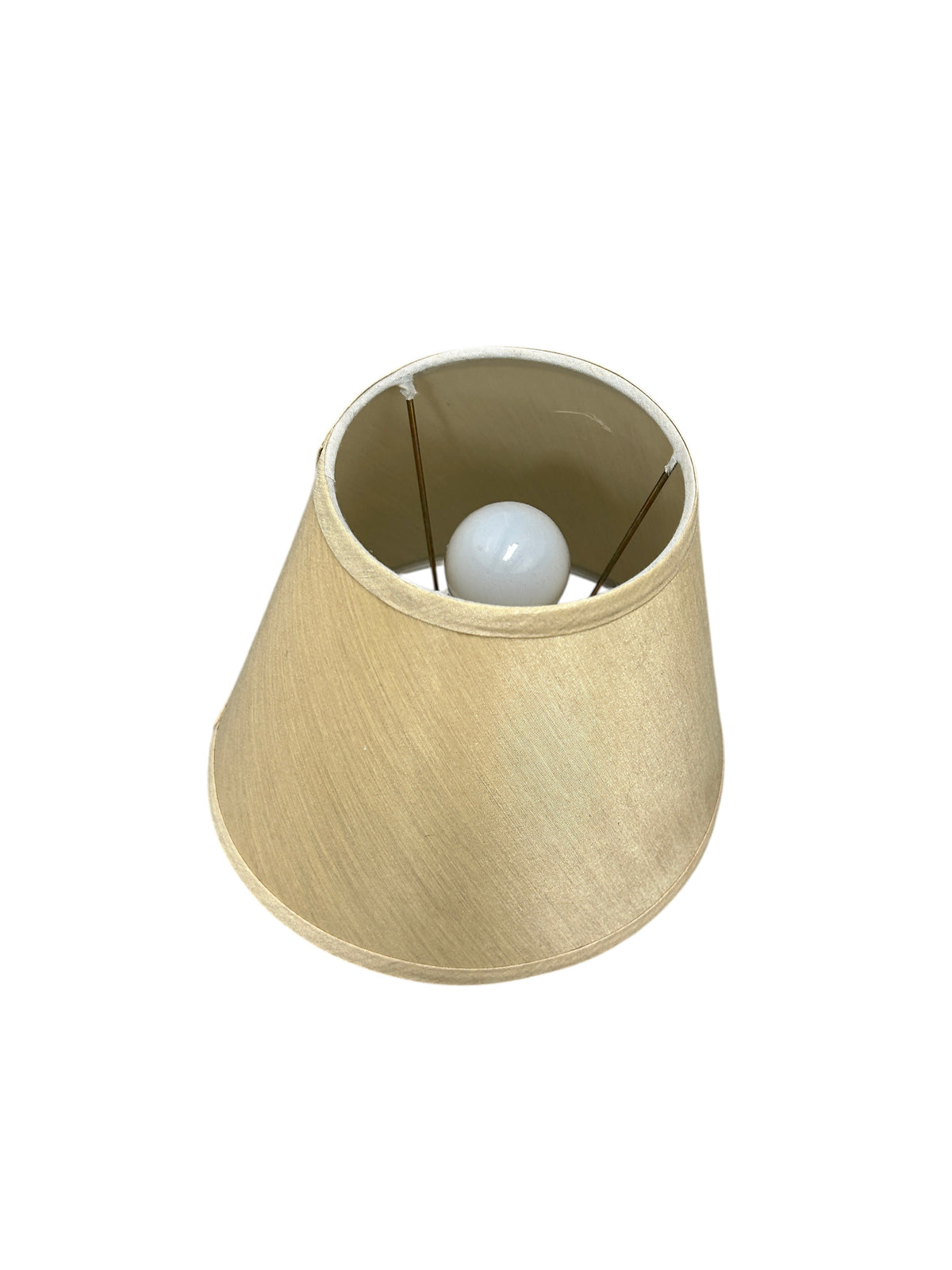 A table lamp with a black ceramic base and beige linen shade.