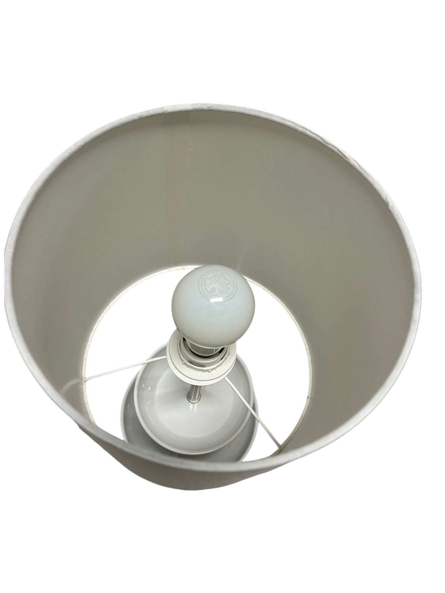 A white cylindrical table lamp.