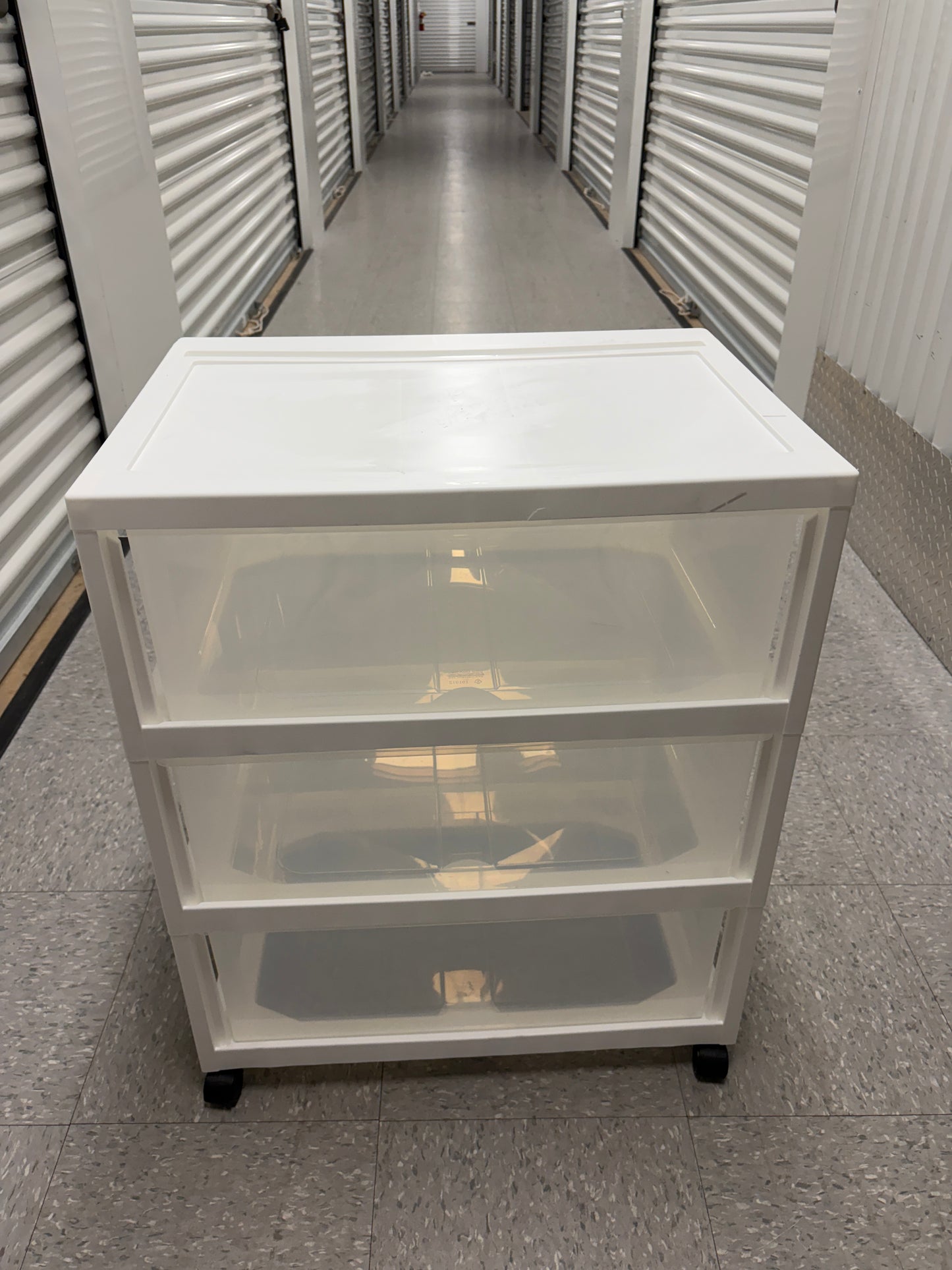 White and clear storage bin on wheels.