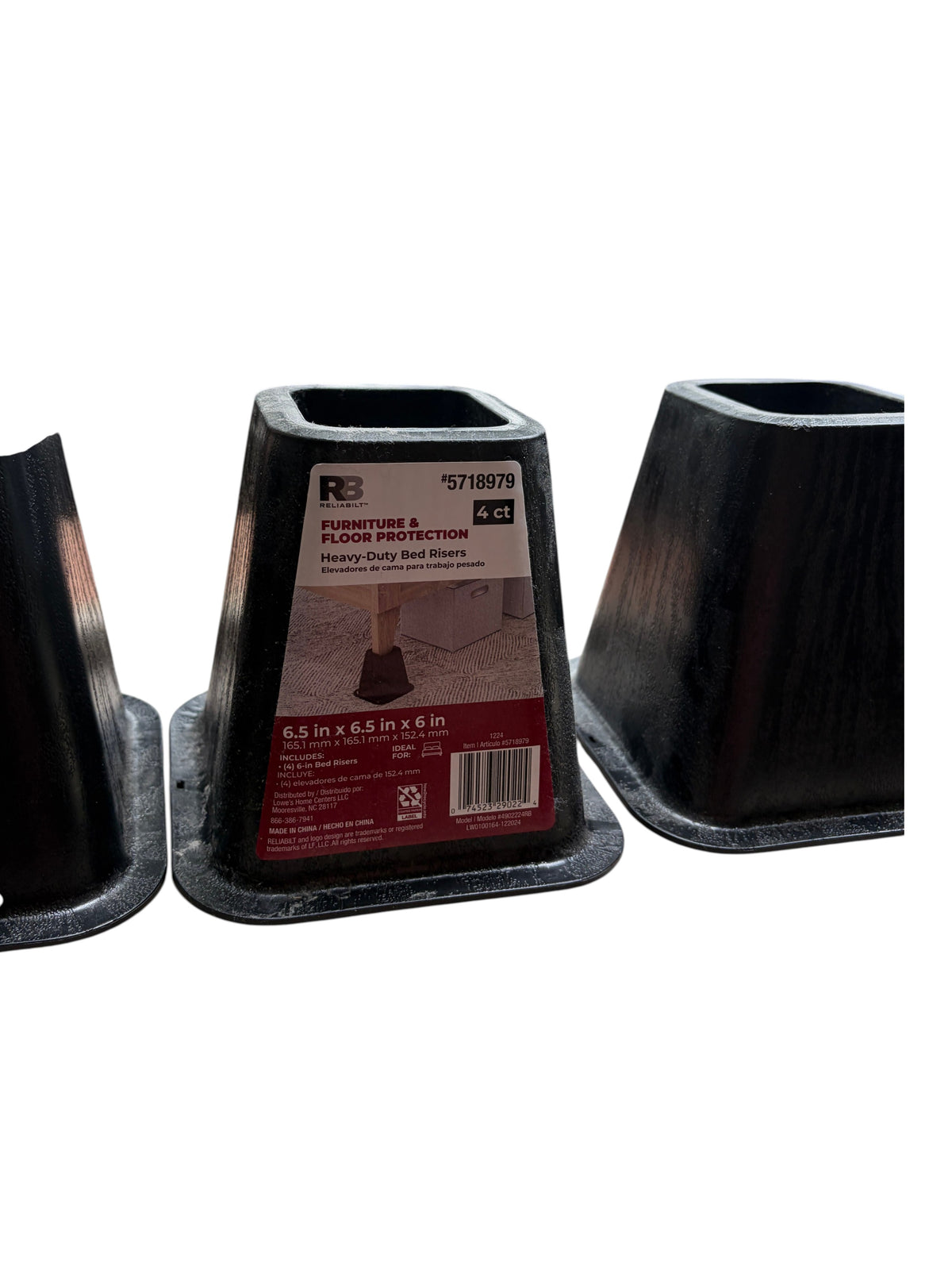 Set of 4 black plastic bed risers.