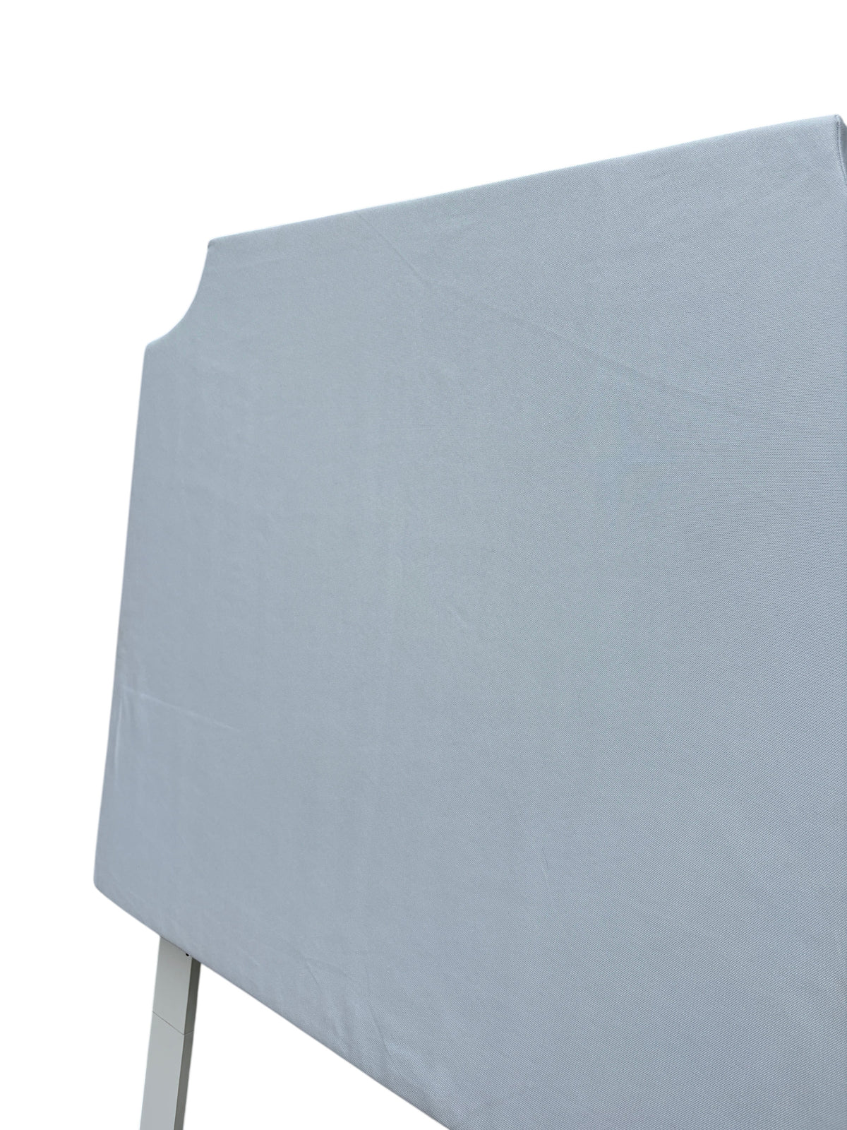 White twin headboard with wooden legs.