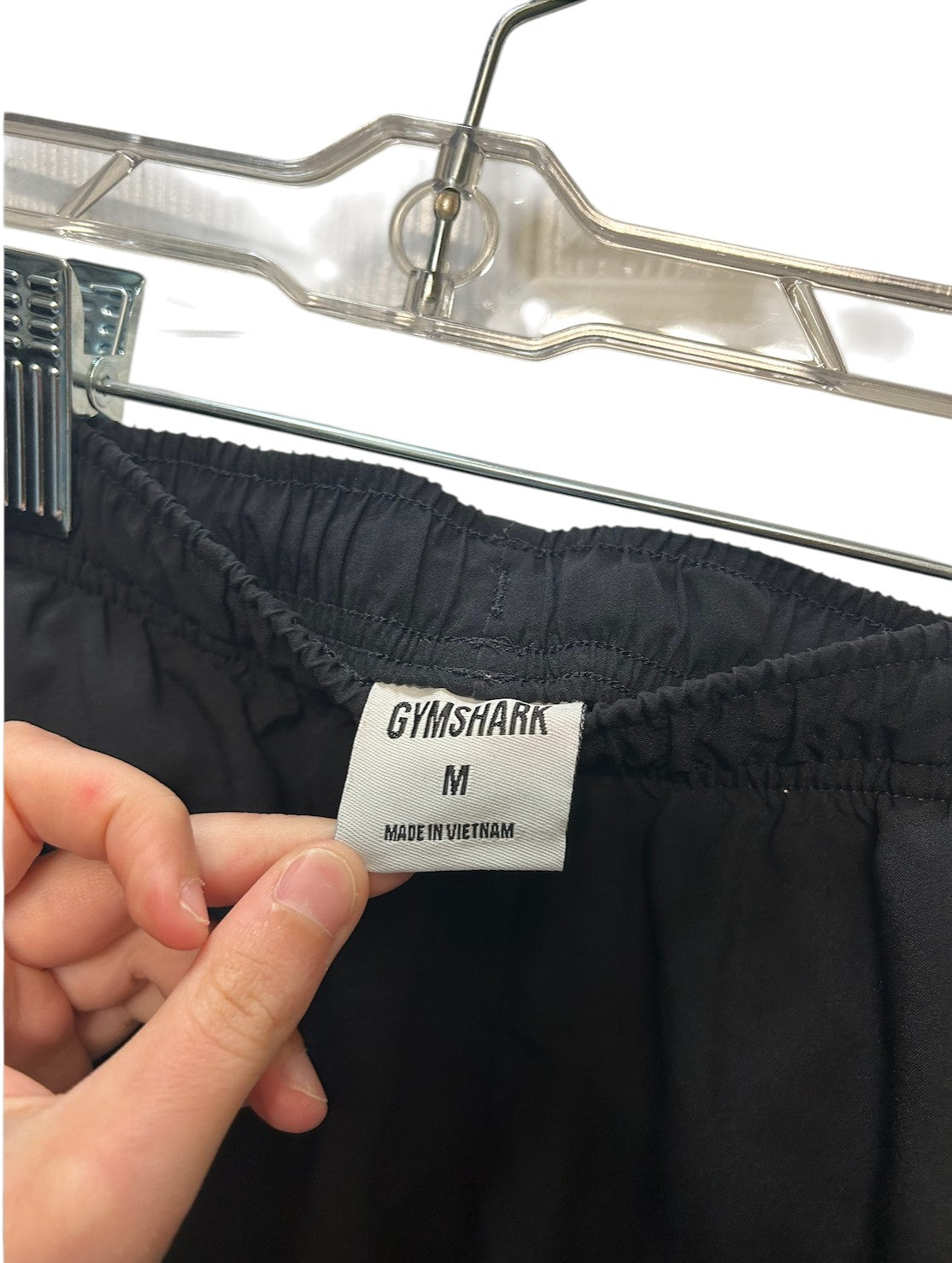 Black Gymshark athletic shorts with elastic waistband and small logo on the leg.