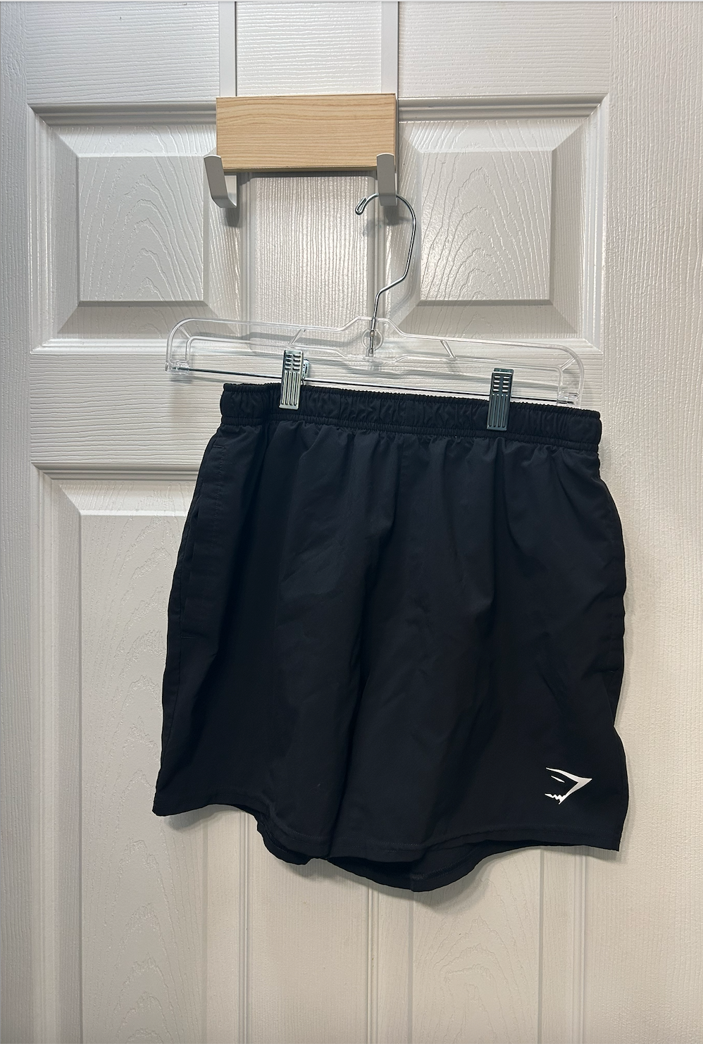 Black Gymshark athletic shorts with elastic waistband and small logo on the leg.