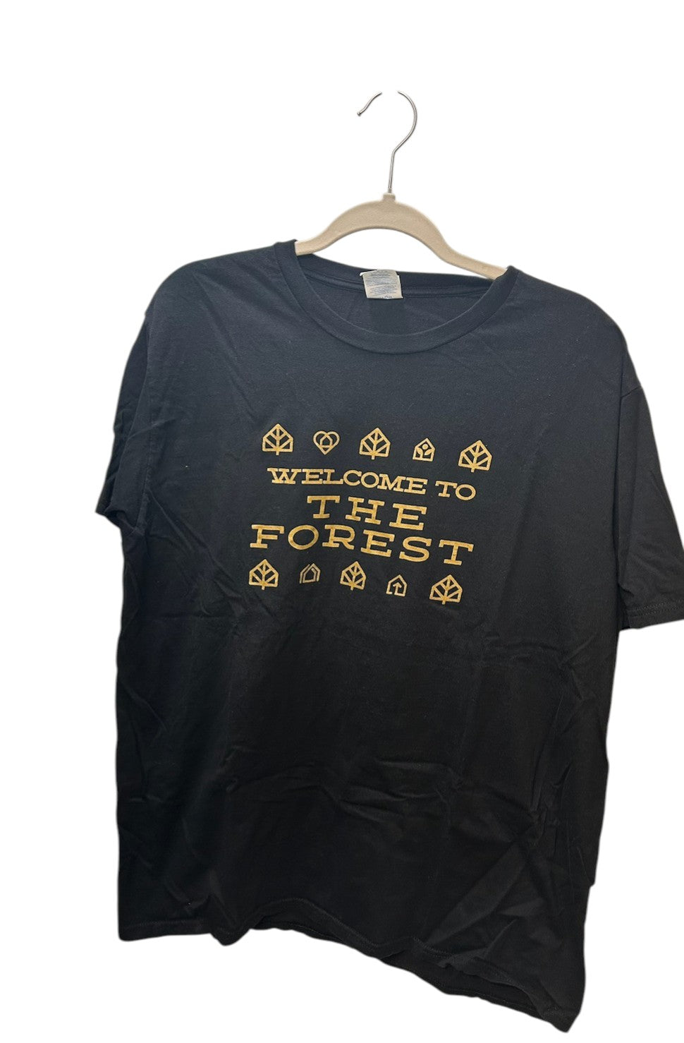Black short-sleeve t-shirt with gold "Welcome to The Forest" graphic print and nature-themed icons.