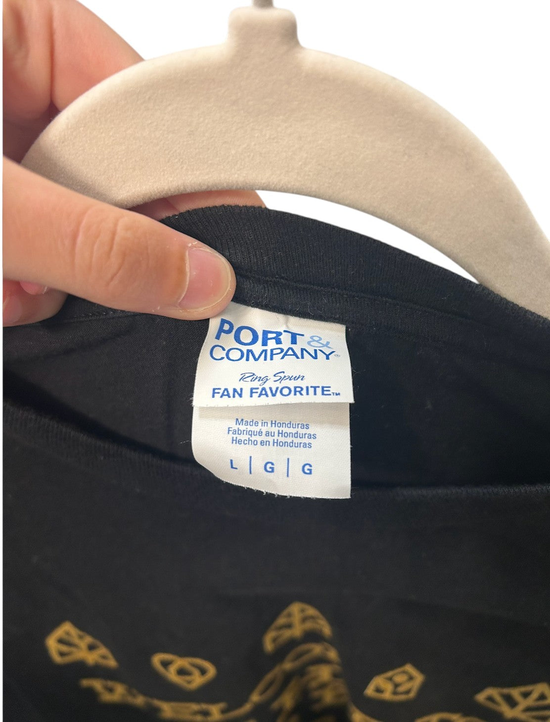 Black short-sleeve t-shirt with gold "Welcome to The Forest" graphic print and nature-themed icons.