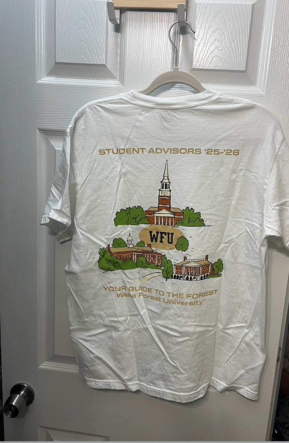 White Wake Forest University Student Advisors '25-'26 t-shirt with campus building graphics.