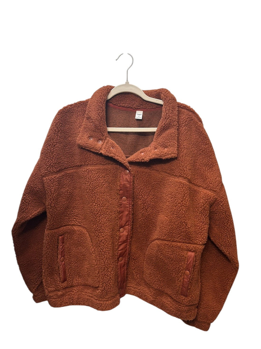 Cozy rust-colored sherpa fleece jacket with snap button closure and front pockets.