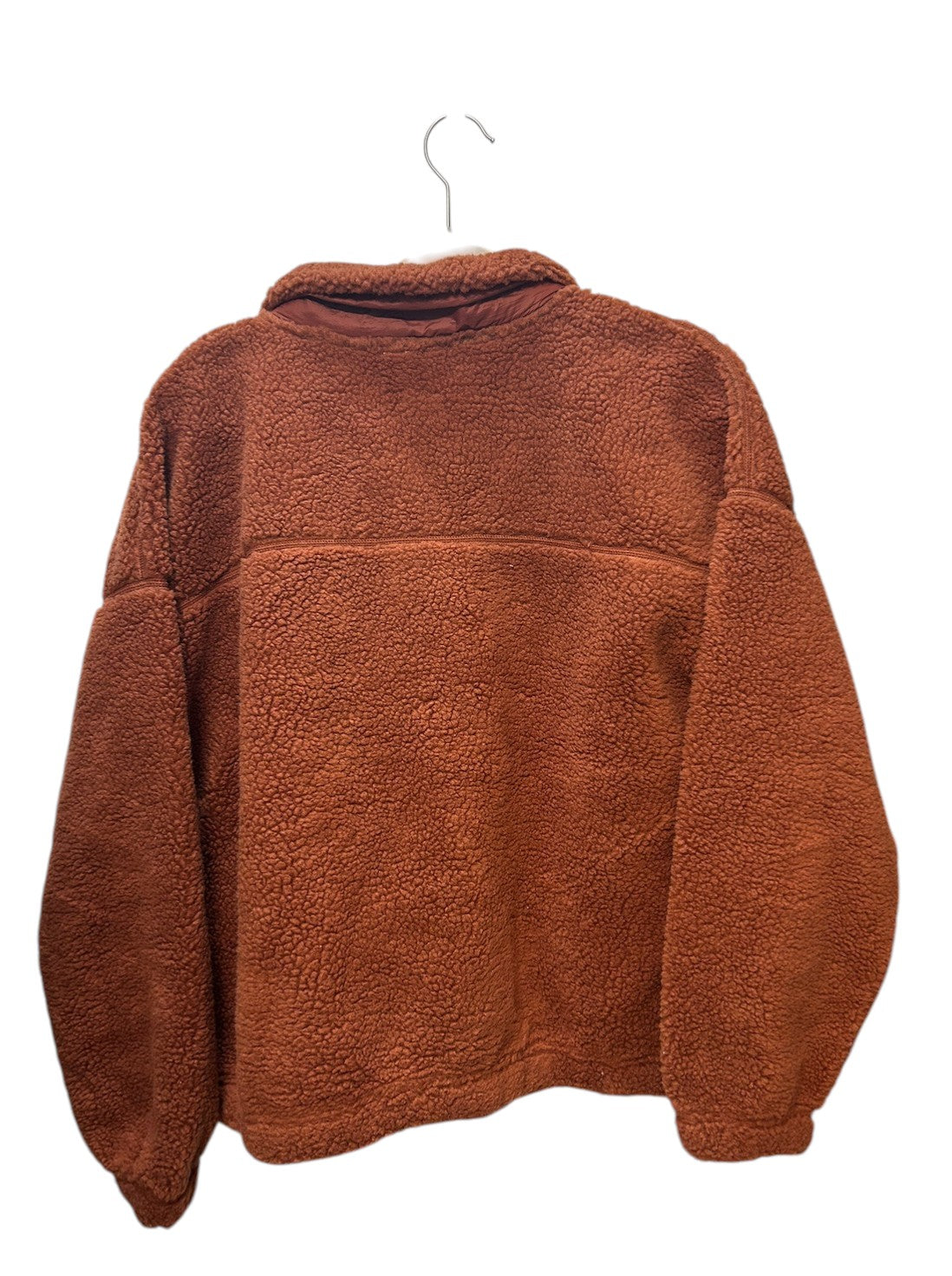 Cozy rust-colored sherpa fleece jacket with snap button closure and front pockets.