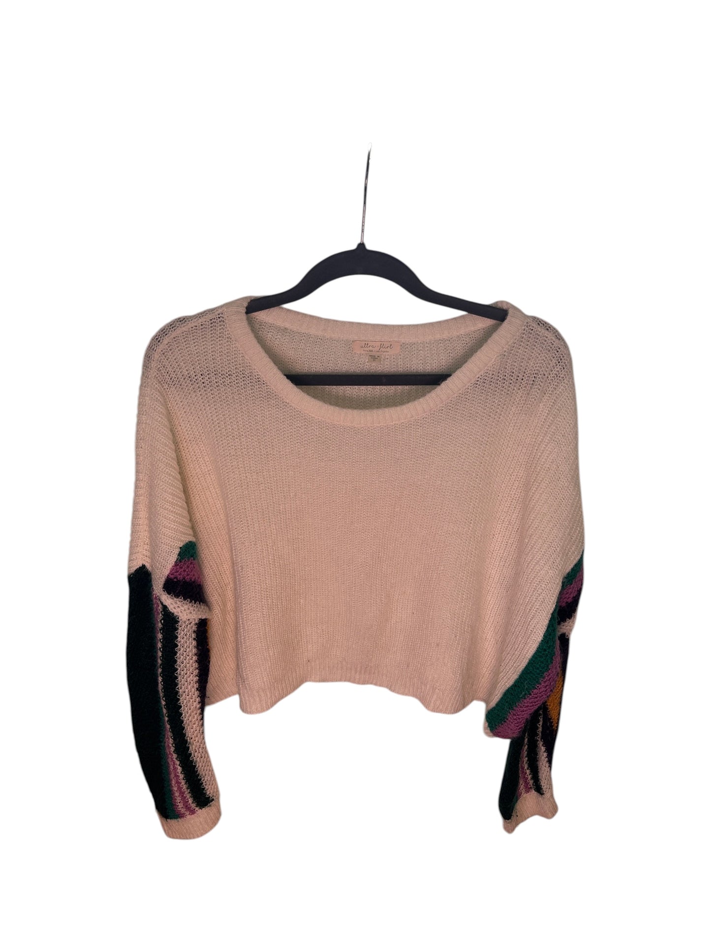 White knit sweater with colorful geometric patterned sleeves featuring green, black, purple, and mustard accents.