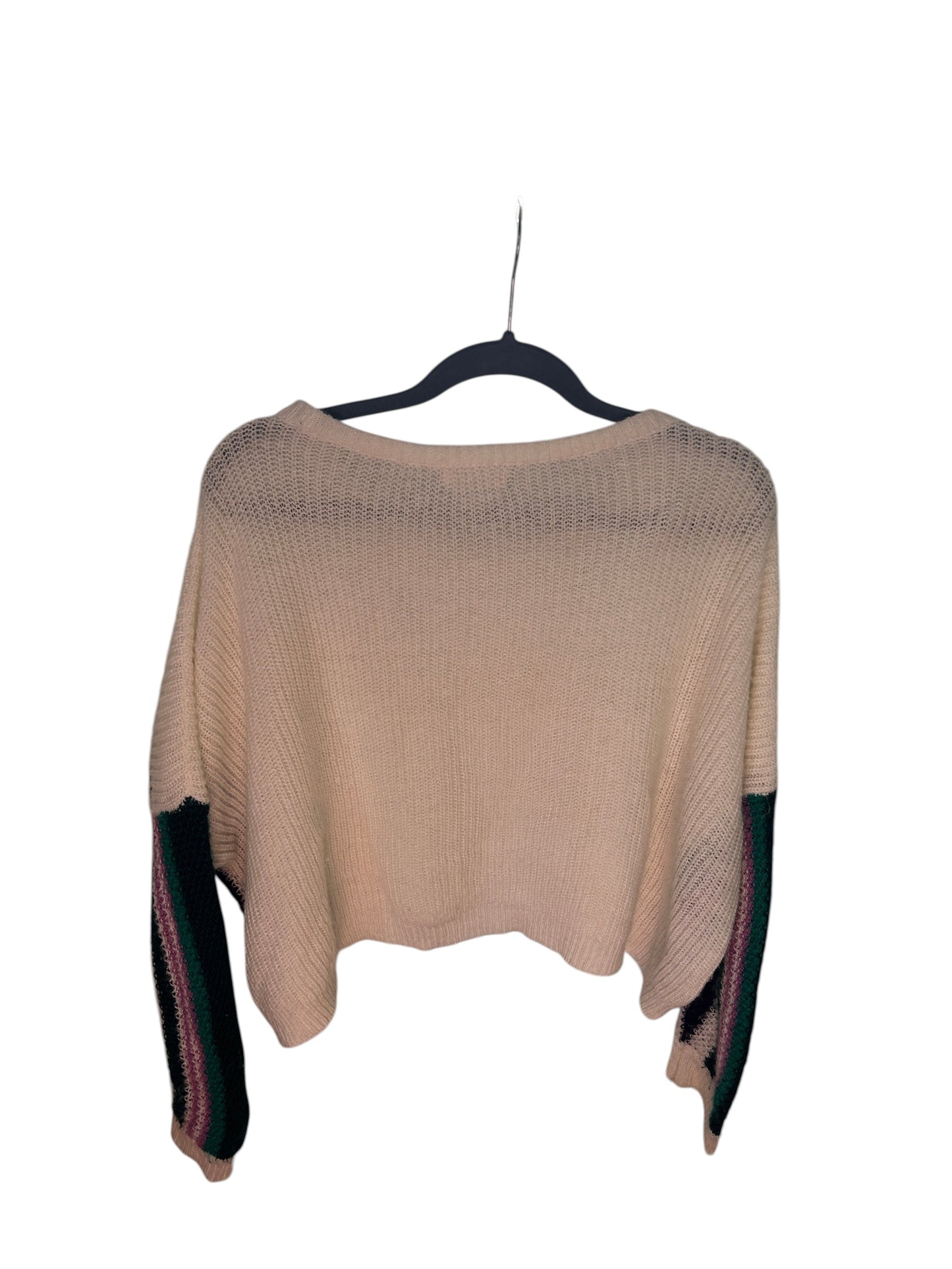 White knit sweater with colorful geometric patterned sleeves featuring green, black, purple, and mustard accents.