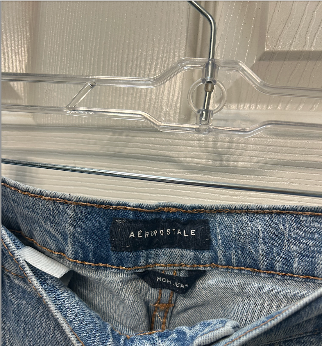 Light wash Aeropostale jeans with raw hem detail and relaxed fit.
