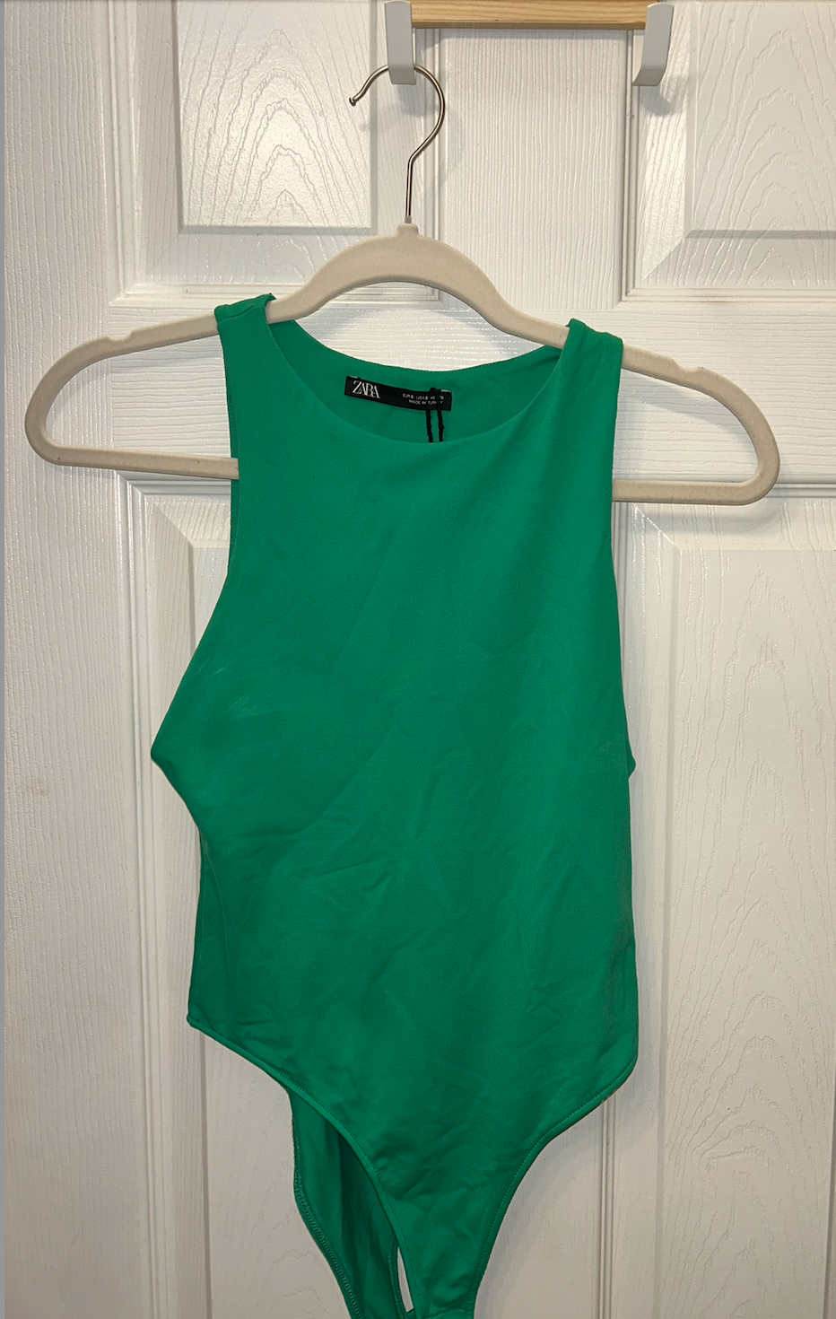 Zara green sleeveless bodysuit with high neckline and snap closure.