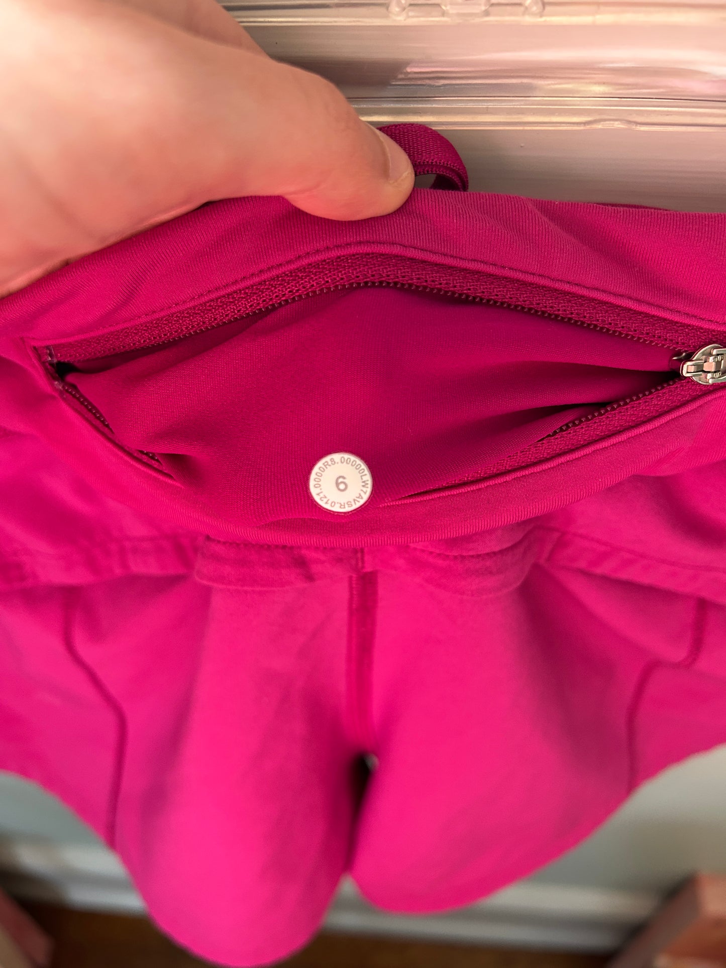 Lululemon magenta athletic running shorts with built-in liner and wide waistband.