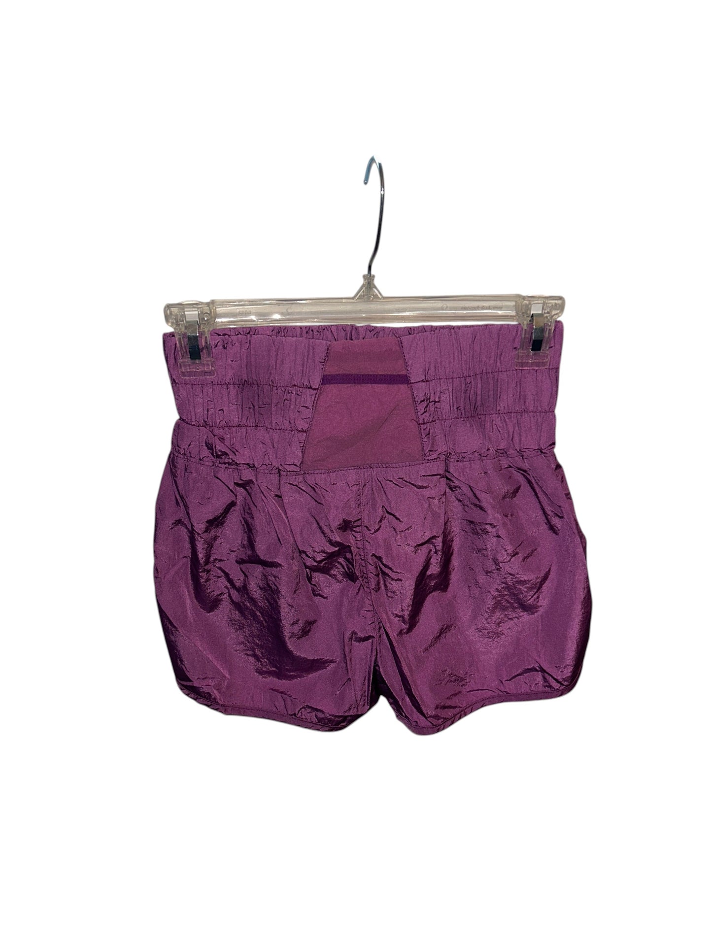 Free People purple athletic shorts with smocked elastic waistband and lightweight crinkled fabric.