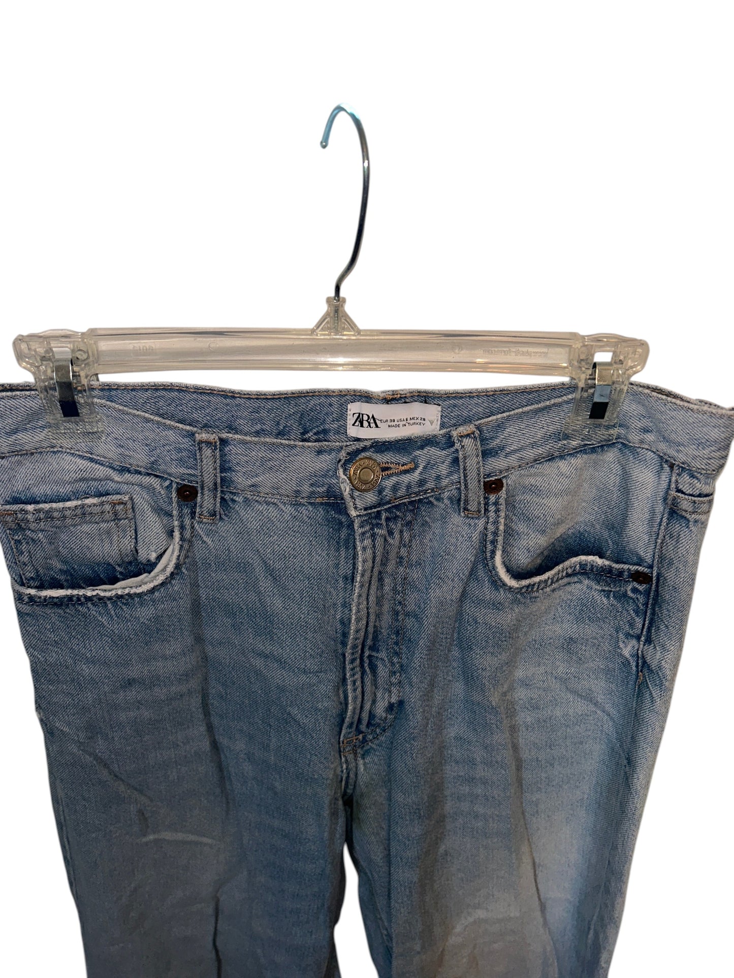 Zara light wash denim jeans with raw hem detailing and a relaxed straight leg fit.