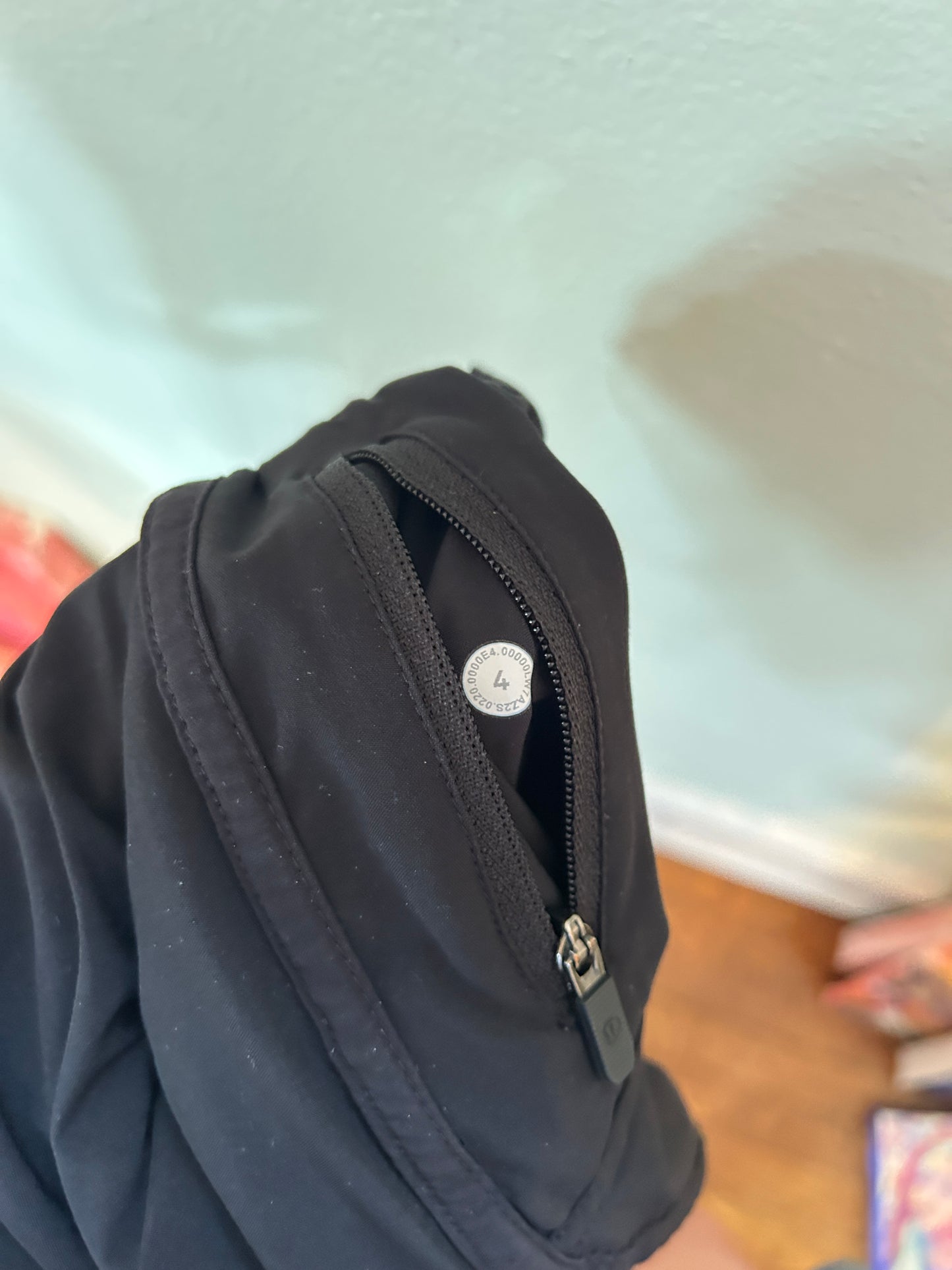 Lululemon black athletic running shorts with elastic waistband and zippered pocket.