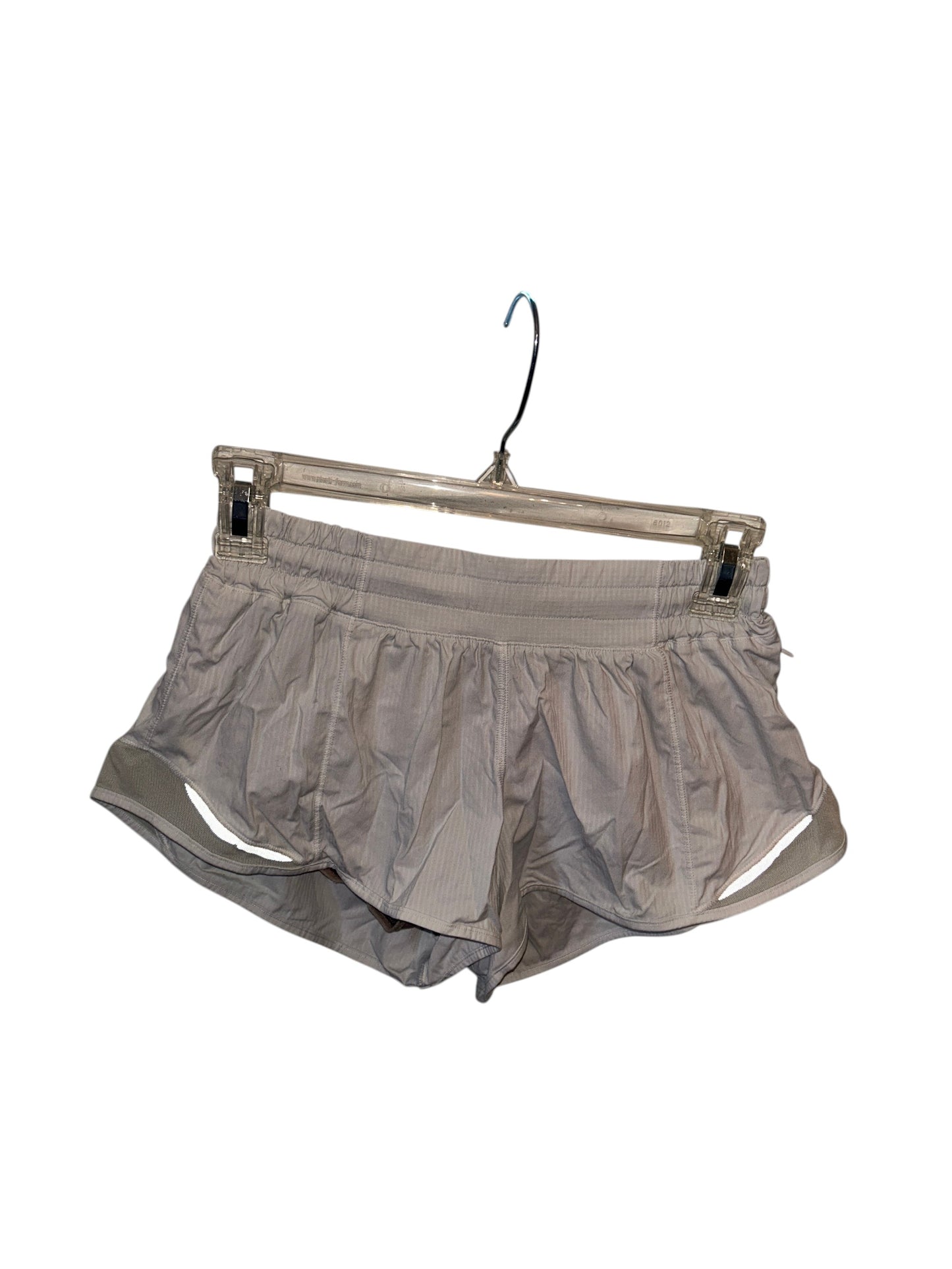 Lululemon white lightweight athletic running shorts with built-in liner and side cutout details.