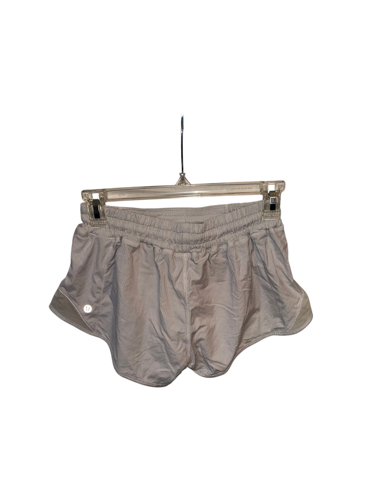 Lululemon white lightweight athletic running shorts with built-in liner and side cutout details.