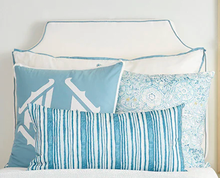 Room 422 white headboard with light blue piping trim along the edges.