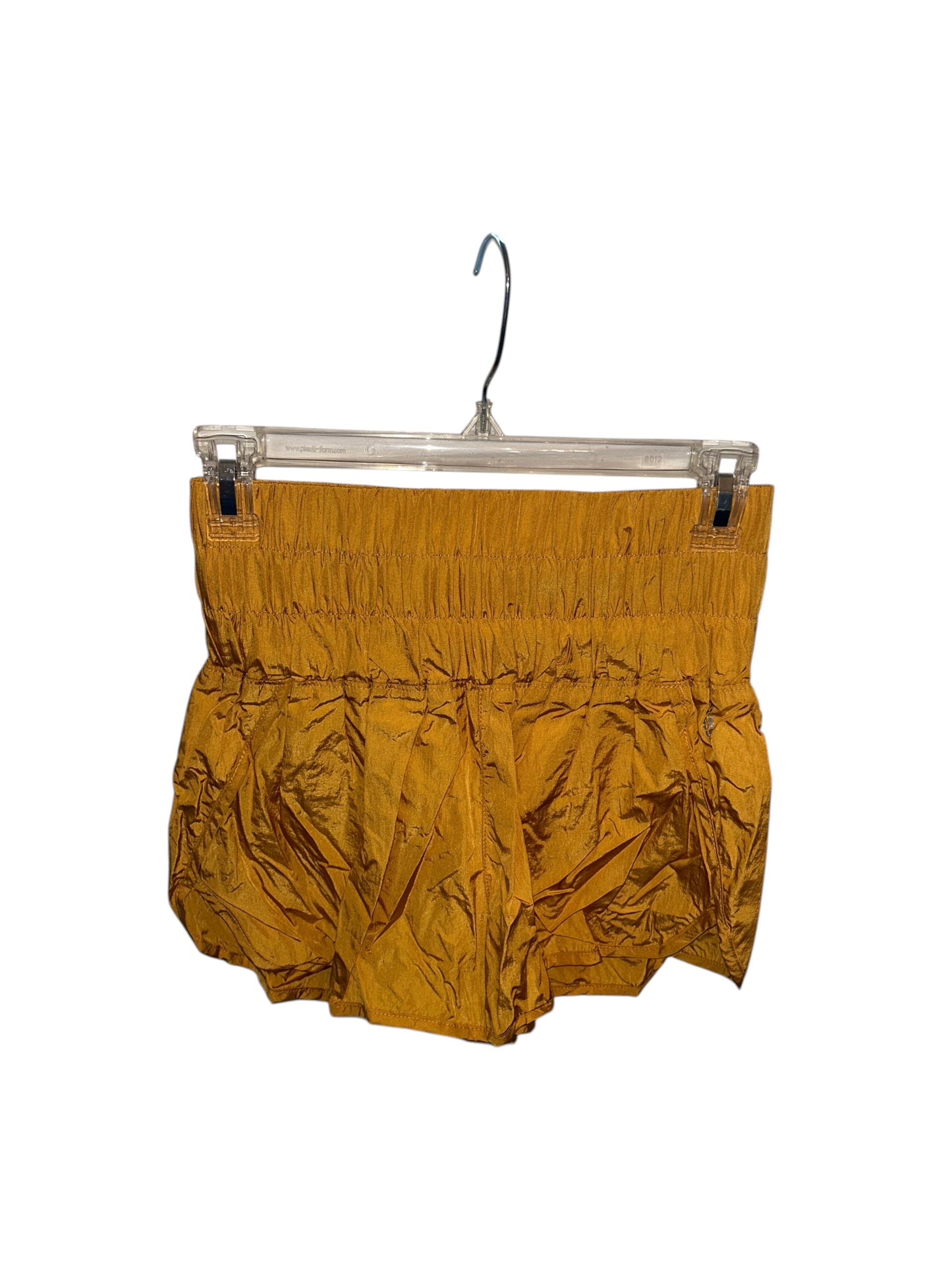 Mustard yellow athletic-style shorts with elastic smocked waistband and lightweight fabric.