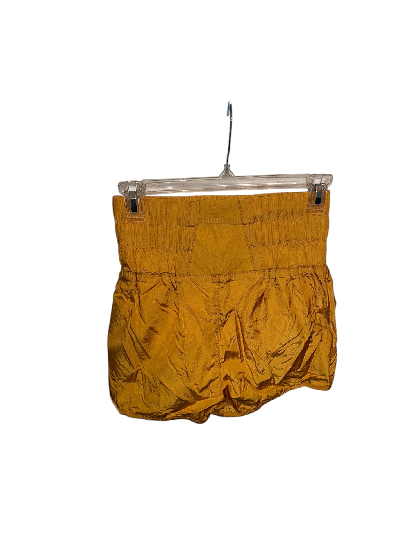 Mustard yellow athletic-style shorts with elastic smocked waistband and lightweight fabric.