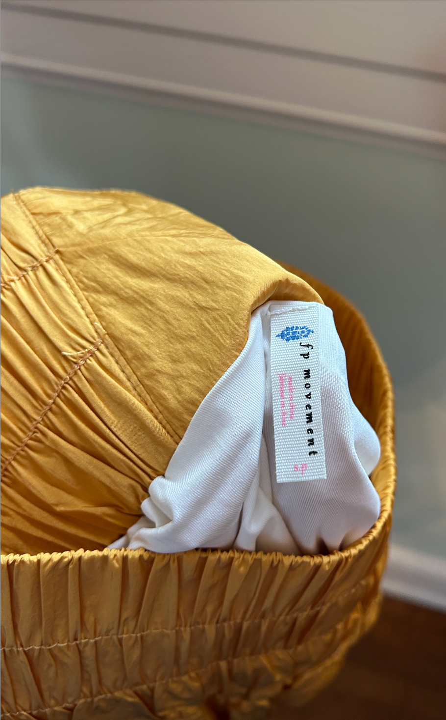 Mustard yellow athletic-style shorts with elastic smocked waistband and lightweight fabric.