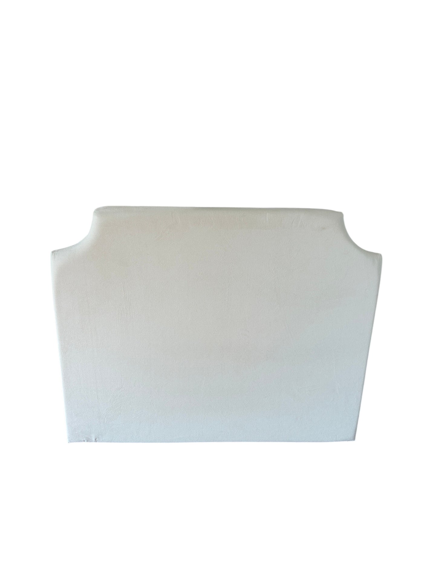 Cream upholstered headboard with curved camelback silhouette.