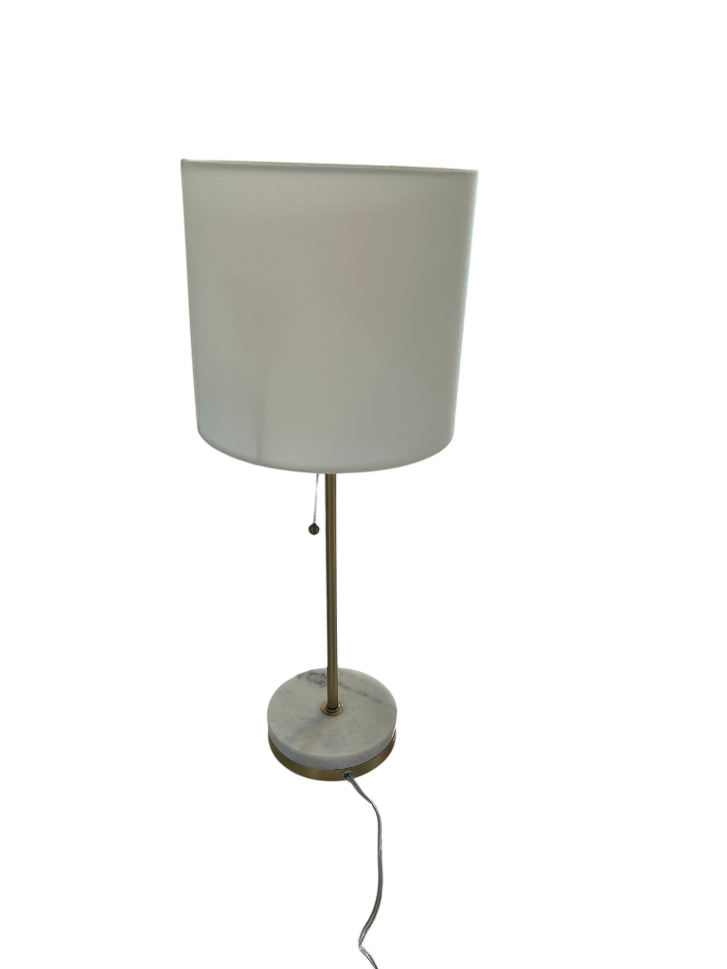 Modern table lamp with white drum shade, brass stem, and marble base with pull chain switch.