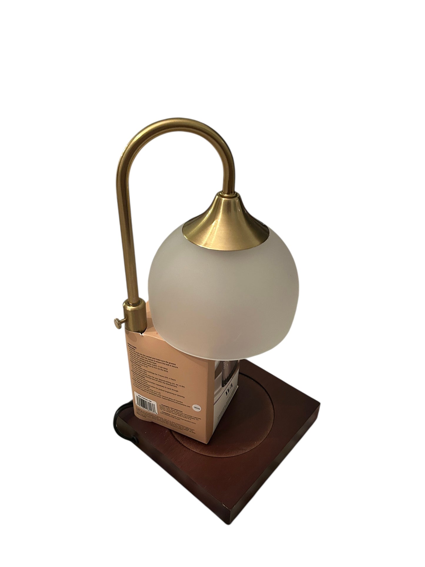 Frosted glass shade candle warmer lamp with brass arm and wooden base.