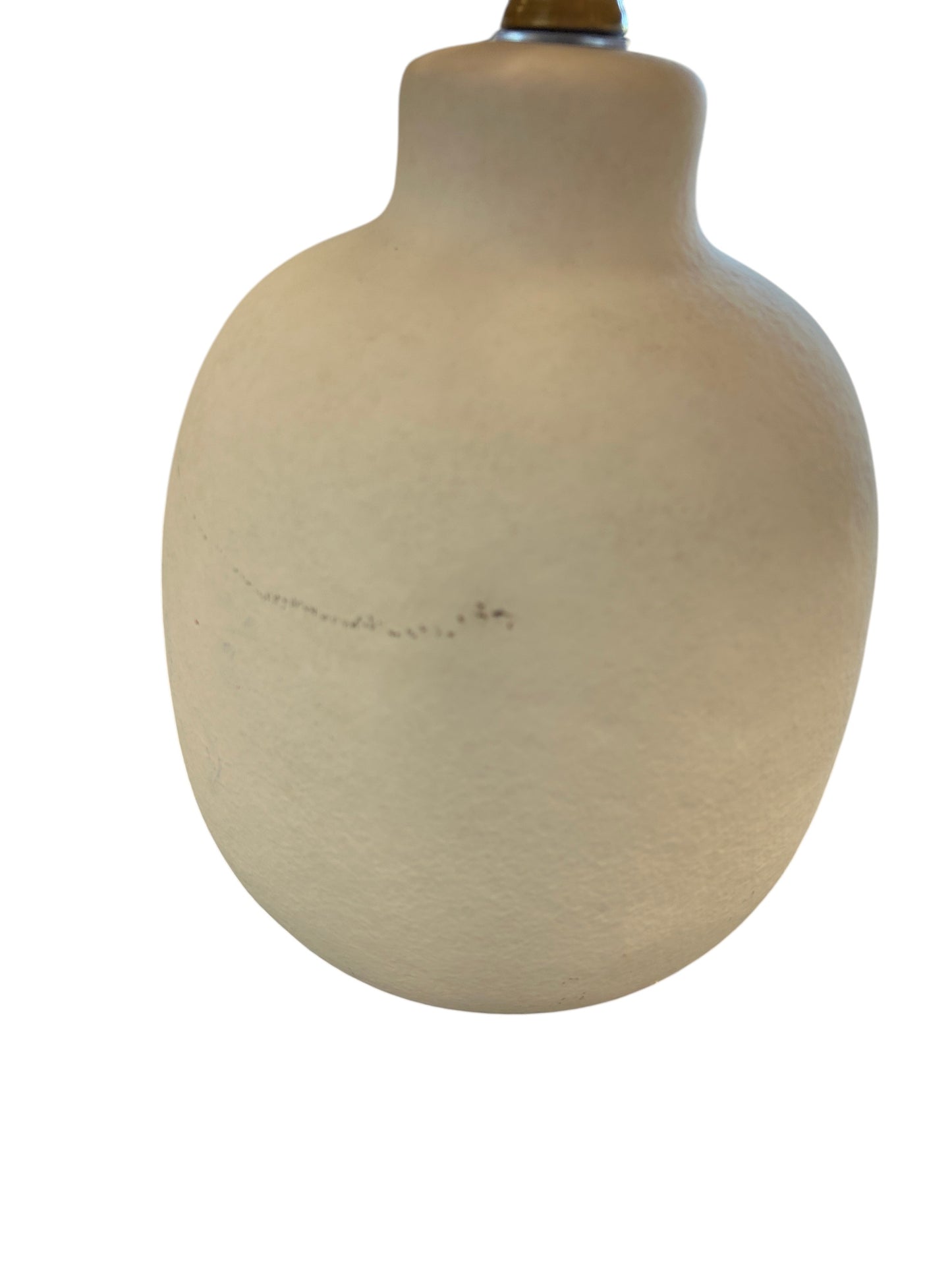 Table lamp with a rounded cream ceramic base and natural woven shade.