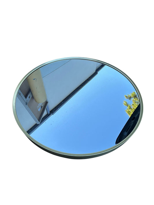 Round wall mirror with a thin gold frame.