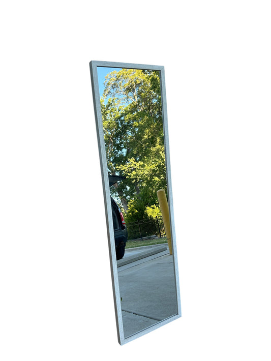 Full-length standing floor mirror with a slim light wooden frame.